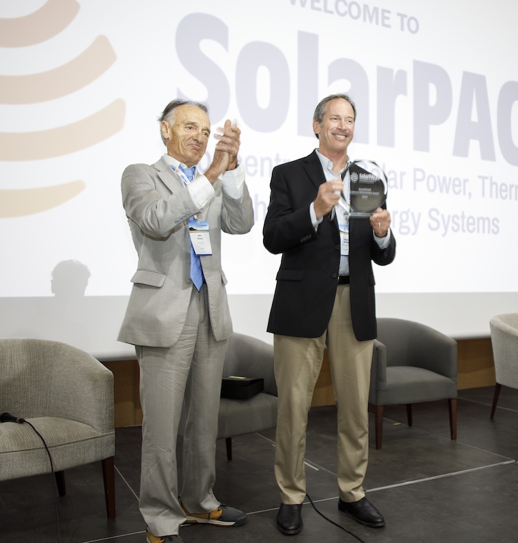 NREL's Mark Mehos accepts the SolarPACES Lifetime Achievement Award he shares with Craig Turchi from Gilles Flamant, Chair of SolarPACES