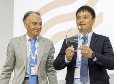 Wan Yuan from Cosin Solar accepts the Technology Implementation Award from SolarPACES Chair Gilles Flamant
