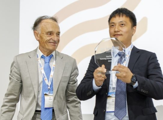 Wan Yuan from Cosin Solar accepts the Technology Implementation Award from SolarPACES Chair Gilles Flamant